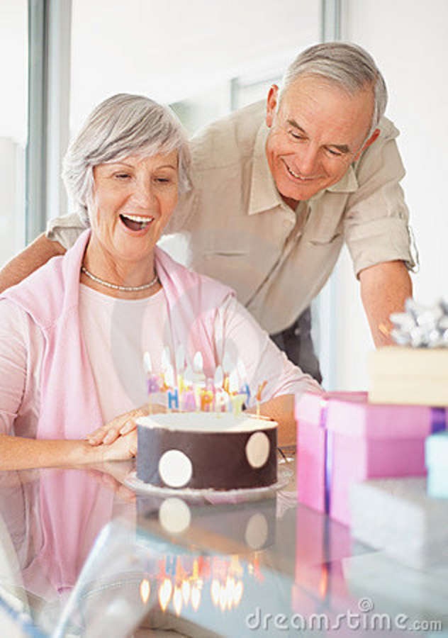 old-couple-celebrating-womans-birthday-home-12255156